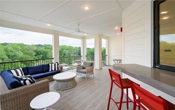 Balcony with a couch and chairs and a table